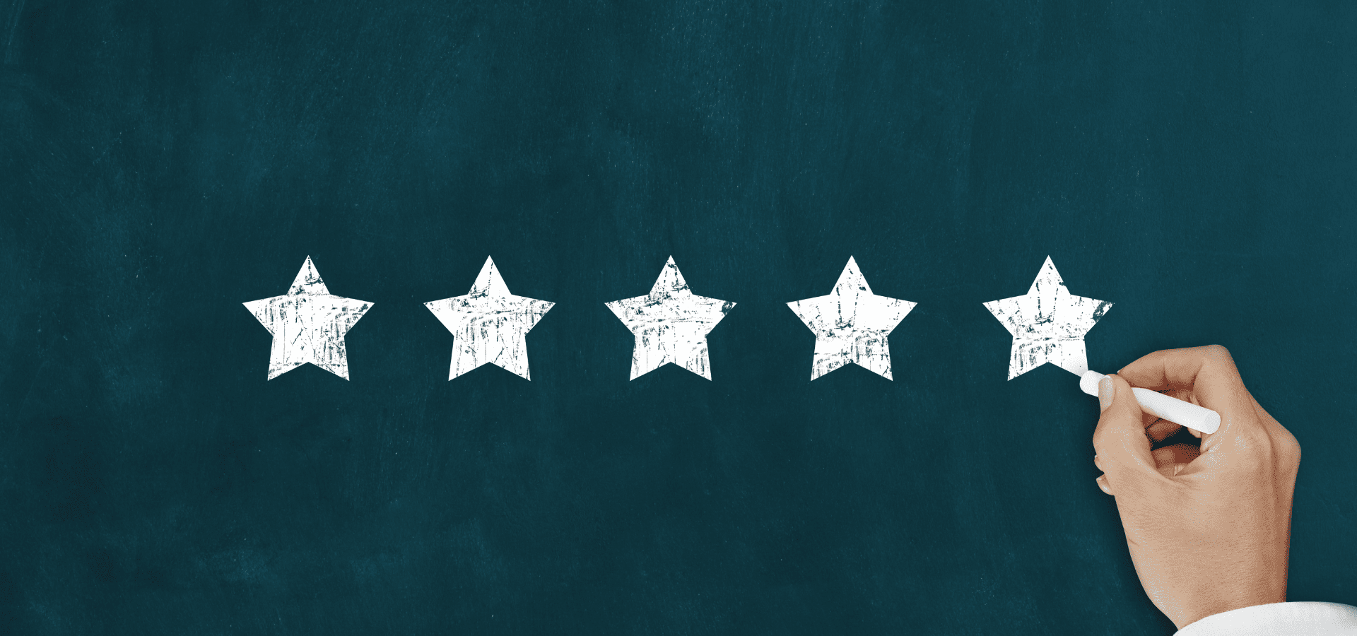 Drawing 5 white stars on a blue chalkboard to symbolize a 5-star review