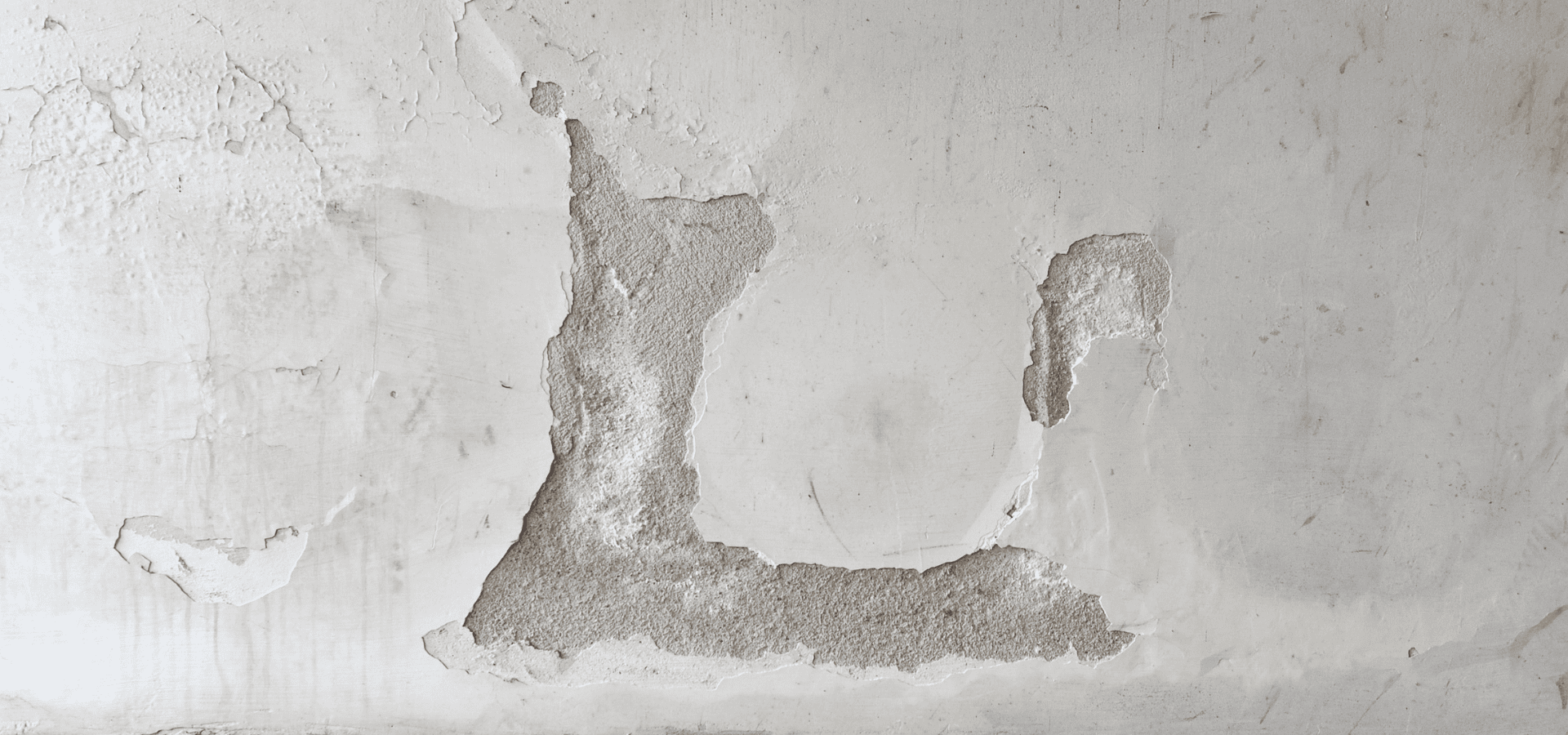 Large holes in wall paint caused by dampness and moisture