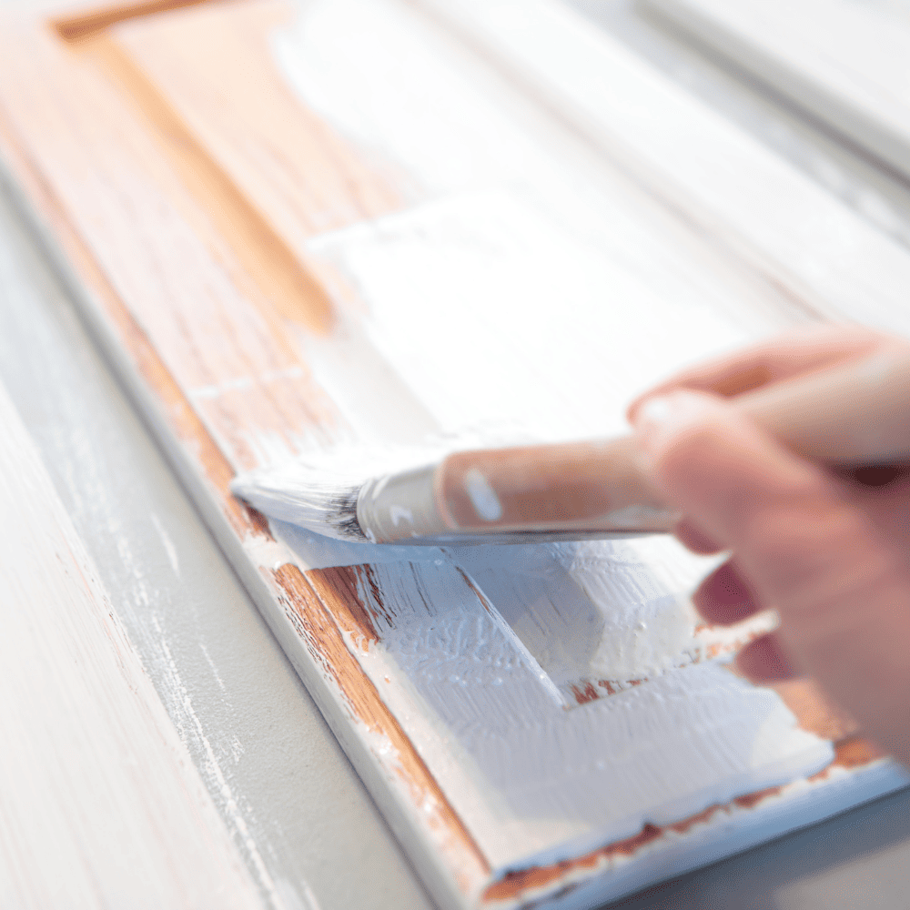 Removing a client's oak kitchen cabinets from the hinges to paint them white