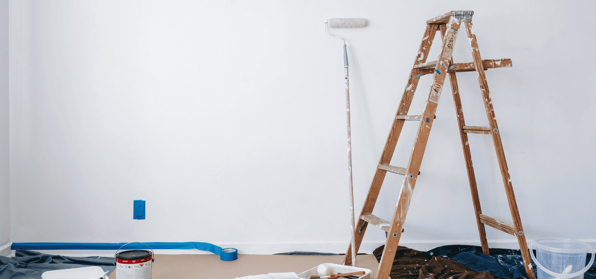 Wooden ladder with paint splashes all over, used for painting