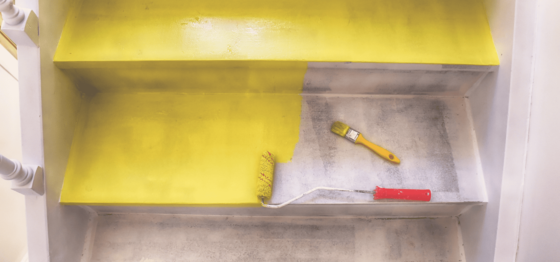 Painting stairs yellow with a mini roller and paintbrush