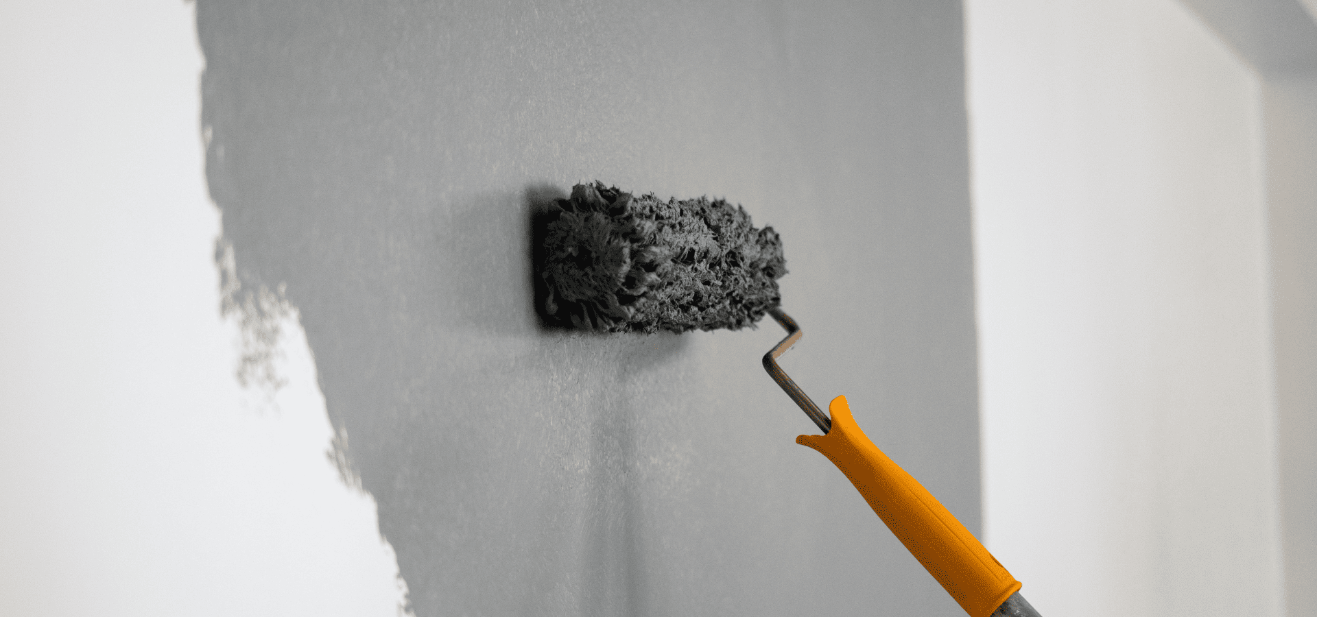 Painting tall walls with a roller connected to a roller extension pole