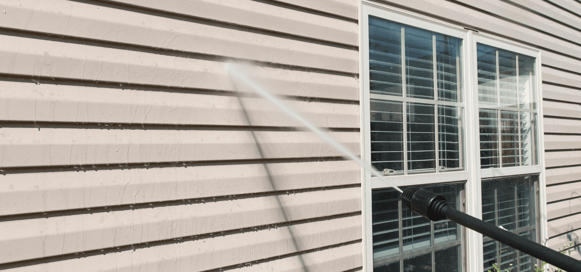Pressure washing the exterior vinyl siding of a mobile home
