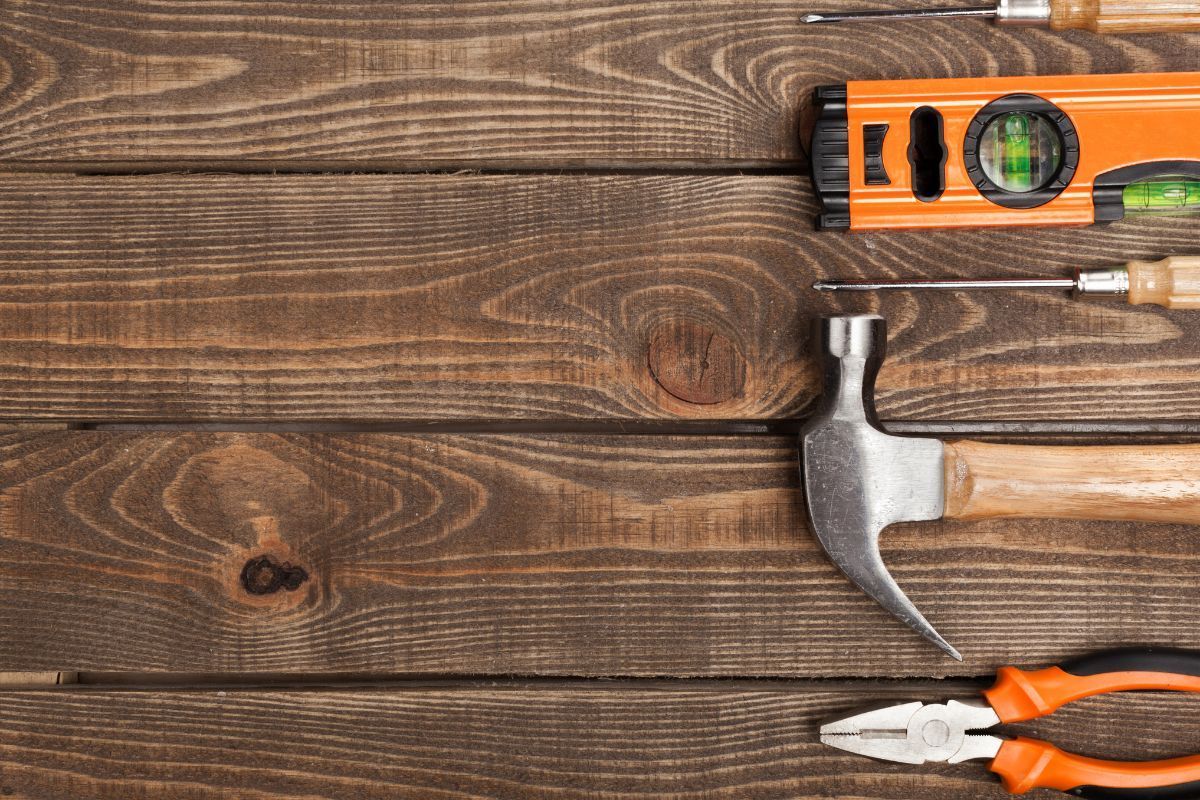 Carpentry tools laid out on a wooden surface for deck repairs in Stockton, CA.