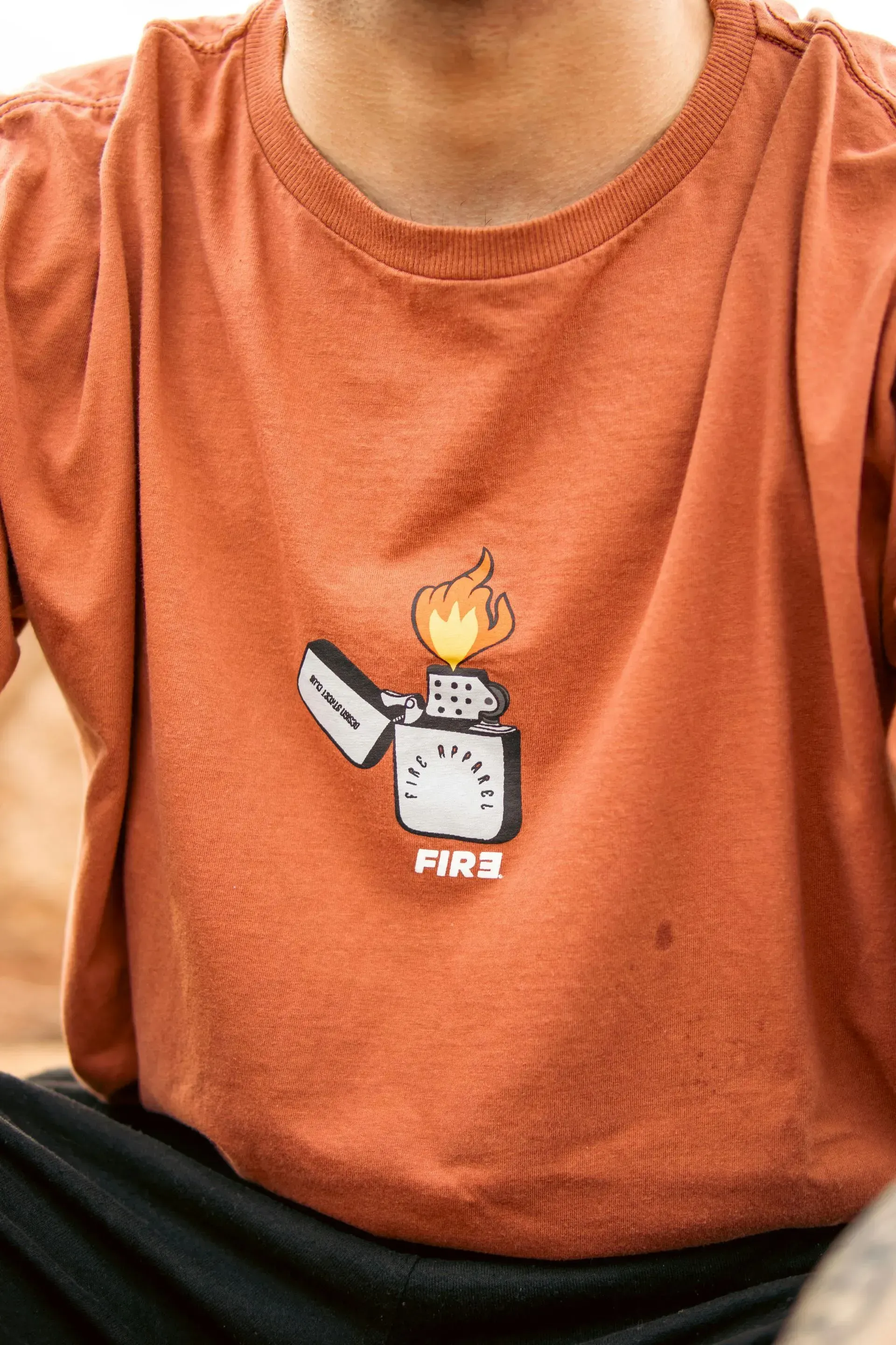 Orange t-shirt with a lighter graphic and 