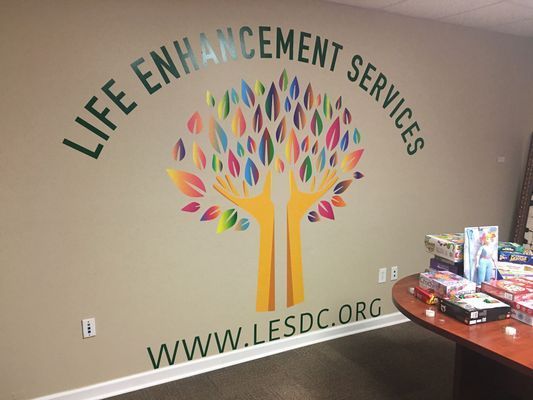 Wall with colorful tree graphic and text: 