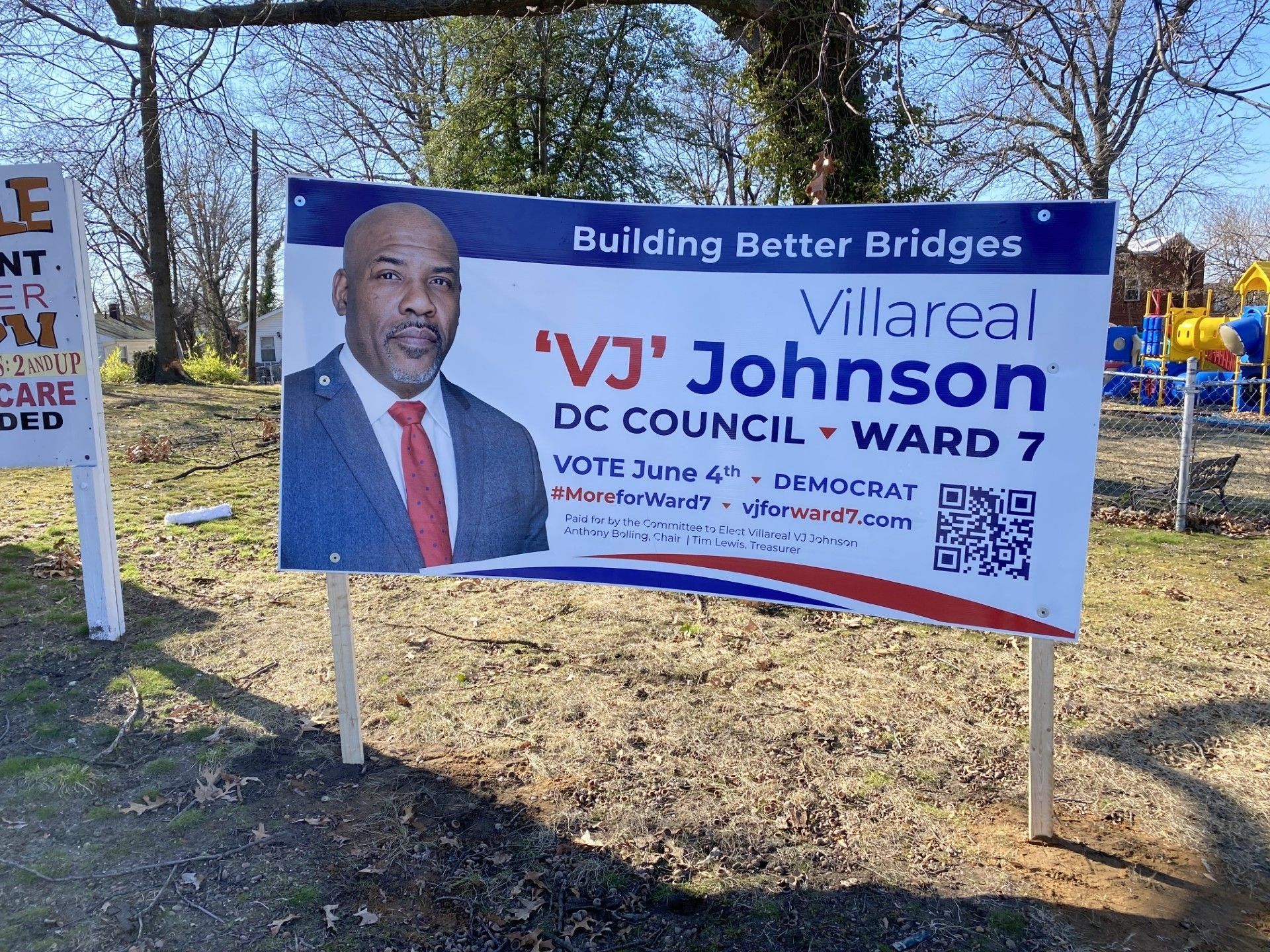 Political sign for 'VJ' Johnson, DC Council Ward 7 candidate. Sign has a portrait, the slogan, and voting details.