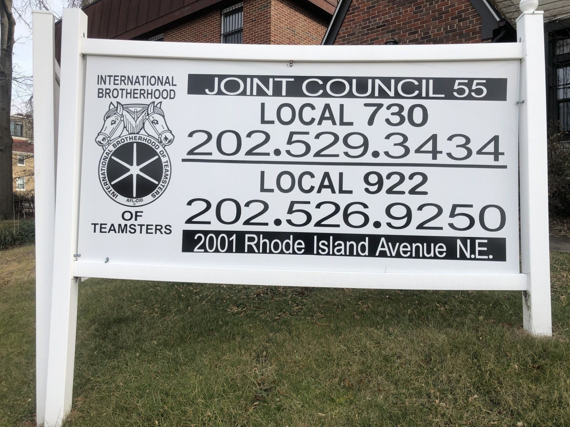 Sign for Teamsters Joint Council 55, with phone numbers and address on white sign.