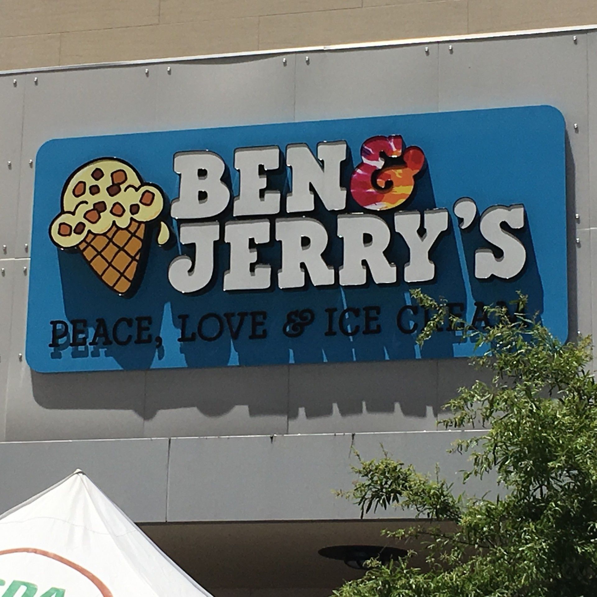 Ben & Jerry's sign, blue with white lettering.  Ice cream cone graphic. 