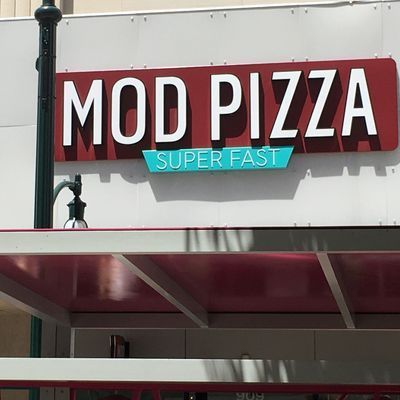 MOD Pizza restaurant sign with red and white letters and teal accent, 