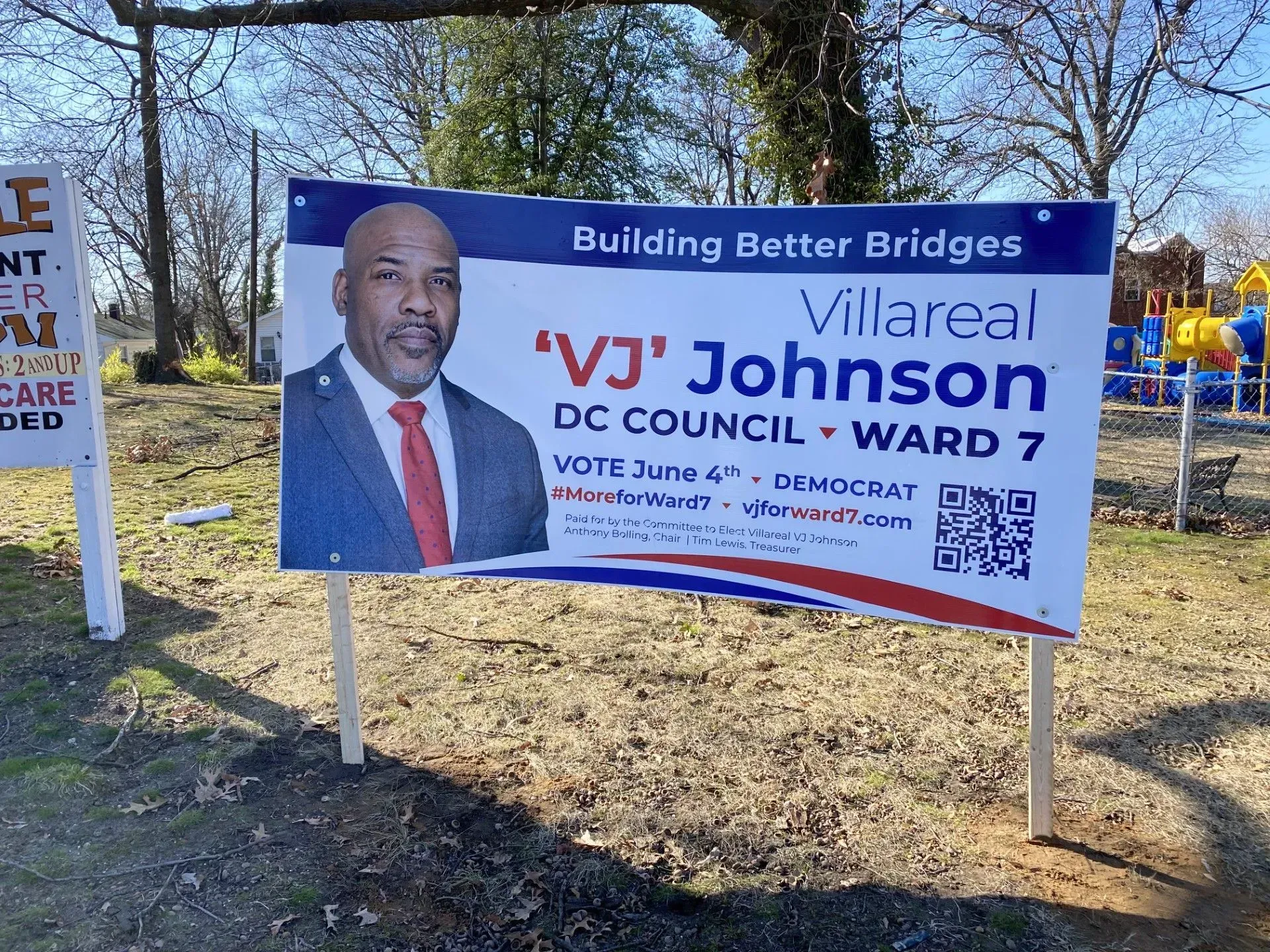 Political campaign sign for 'VJ' Johnson, DC Council Ward 7, with his photo and slogan 