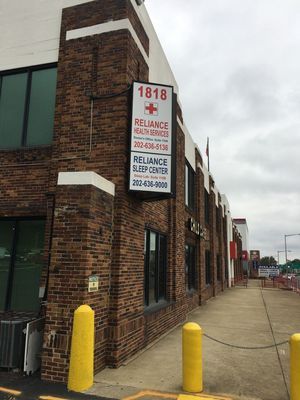 Exterior of brick building with sign for Reliance Health Services and Sleep Center, address 1818.