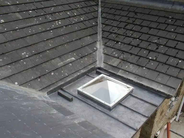 Gray slate roof with a skylight.