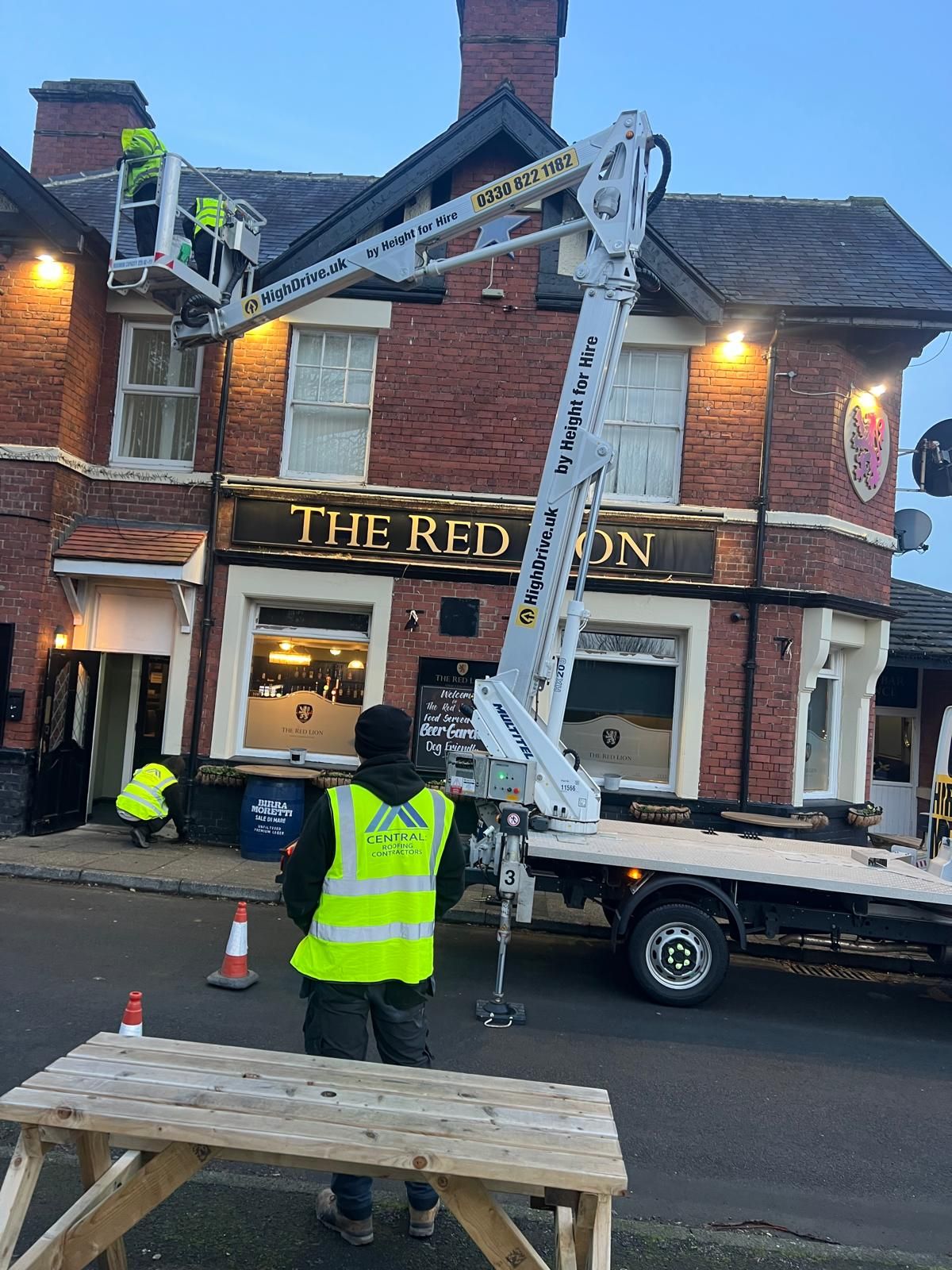 Workers on a lift outside 