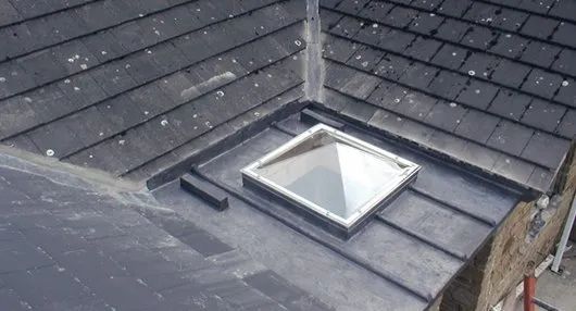 Slate roof with skylight and lead flashing.