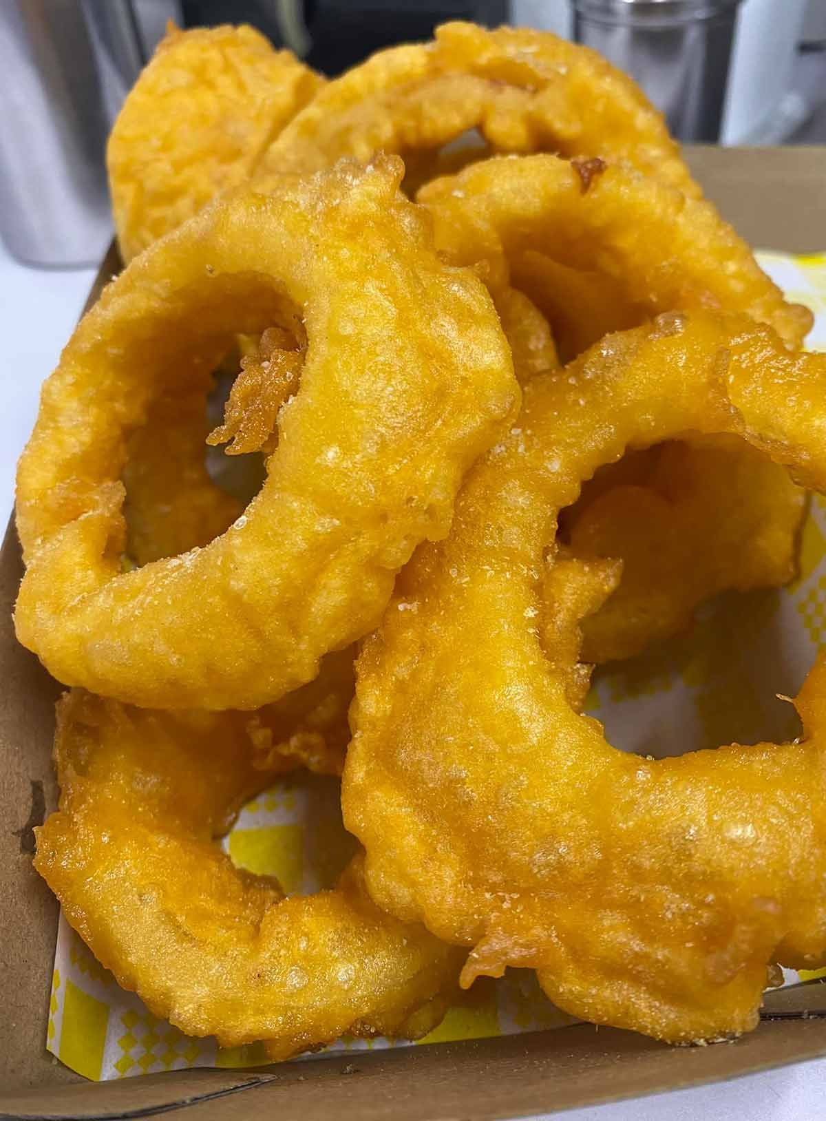 A Close Up of Fried Onion Rings — Cedar Park Fish & Chips In Taranganba, QLD