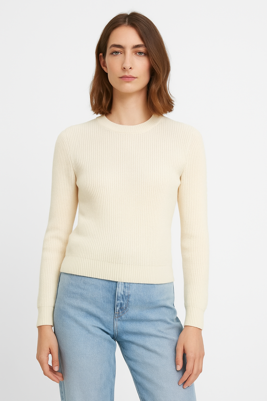 Una donna che indossa un maglione bianco e jeans blu