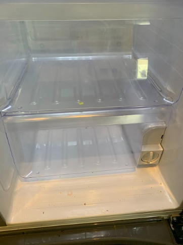 Open refrigerator with empty clear shelves and door bins.