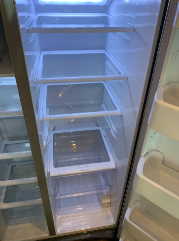 Empty glass-door refrigerator with several wire shelves and blue interior light
