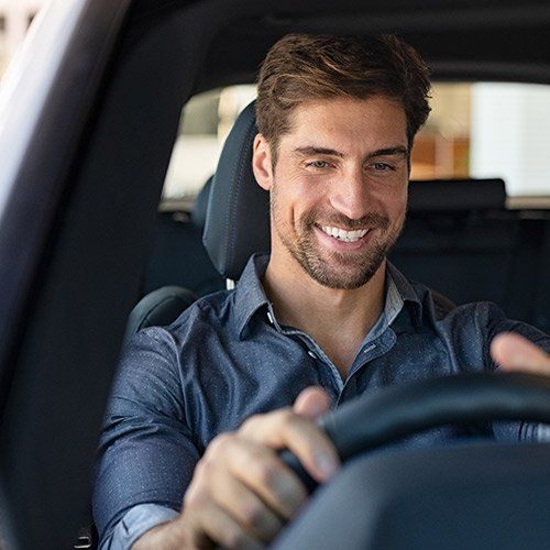 a man driving while smiling
