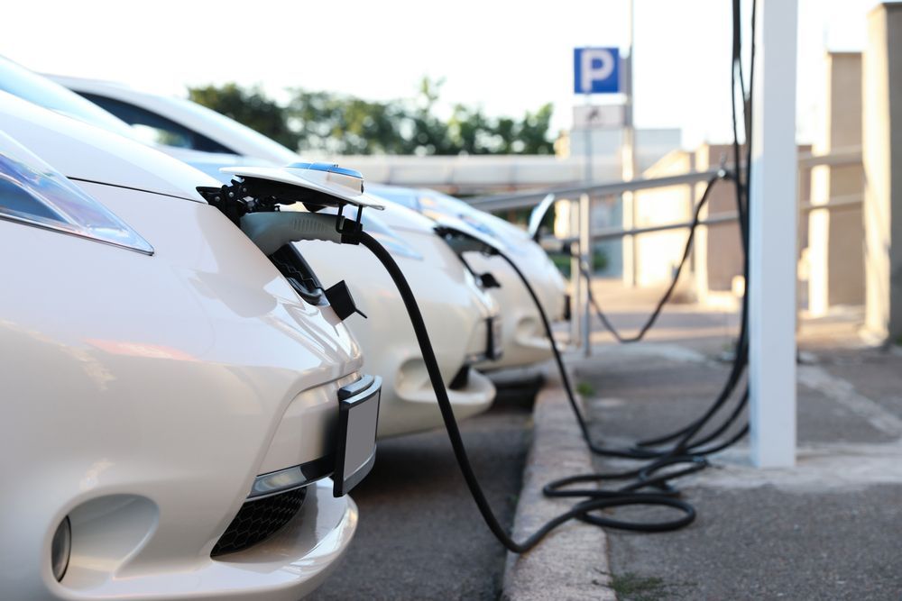 White Electric Cars Charging At A Charging Station, With Cables Connected — GSA Group In Garbutt, QLD