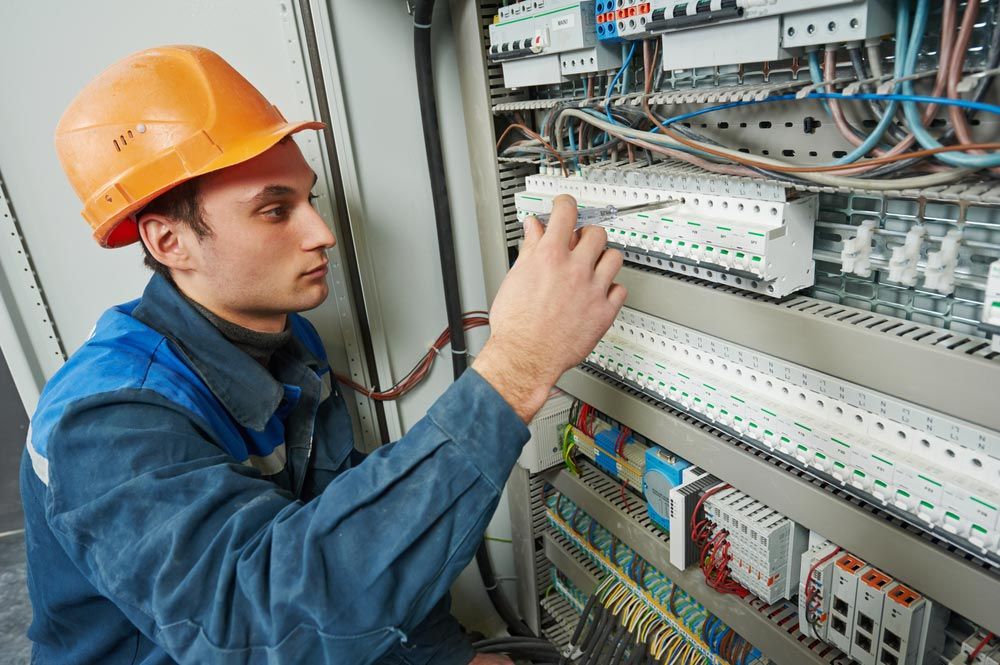 Electrician Using Electric Meter Tester — GSA Group In Garbutt, QLD