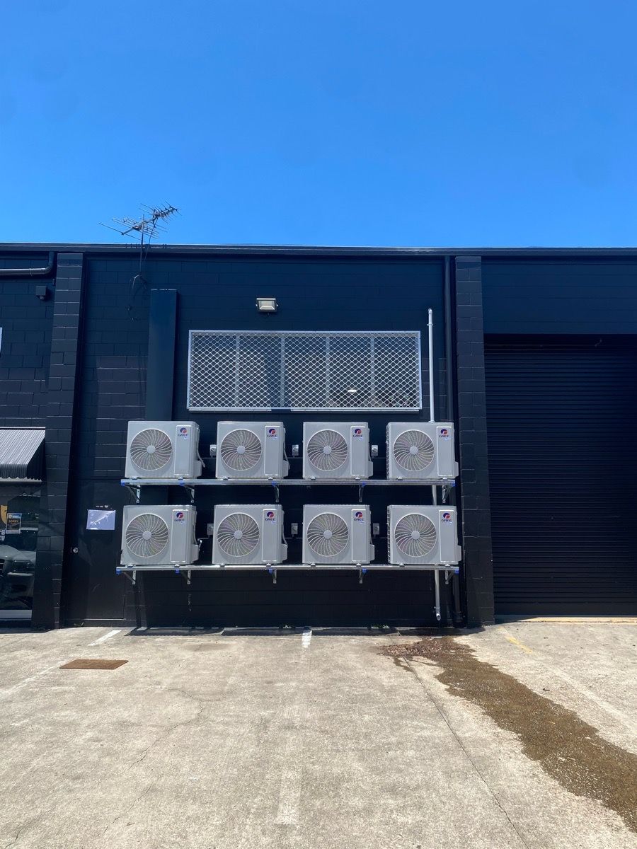 Man Is Using A Remote Control To Set The Temperature — GSA Group In Garbutt, QLD