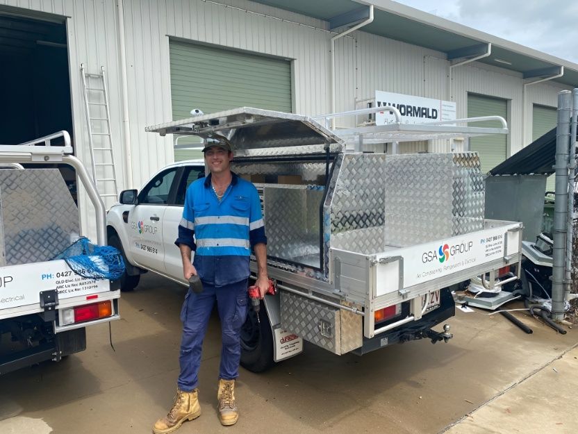 Technician Smiling Whilst Standing Next to Company Ute — GSA Group In Garbutt, QLD