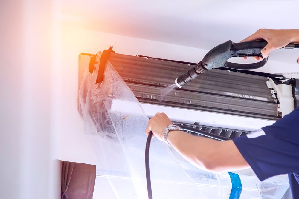 Man Cleaning Air Conditioner