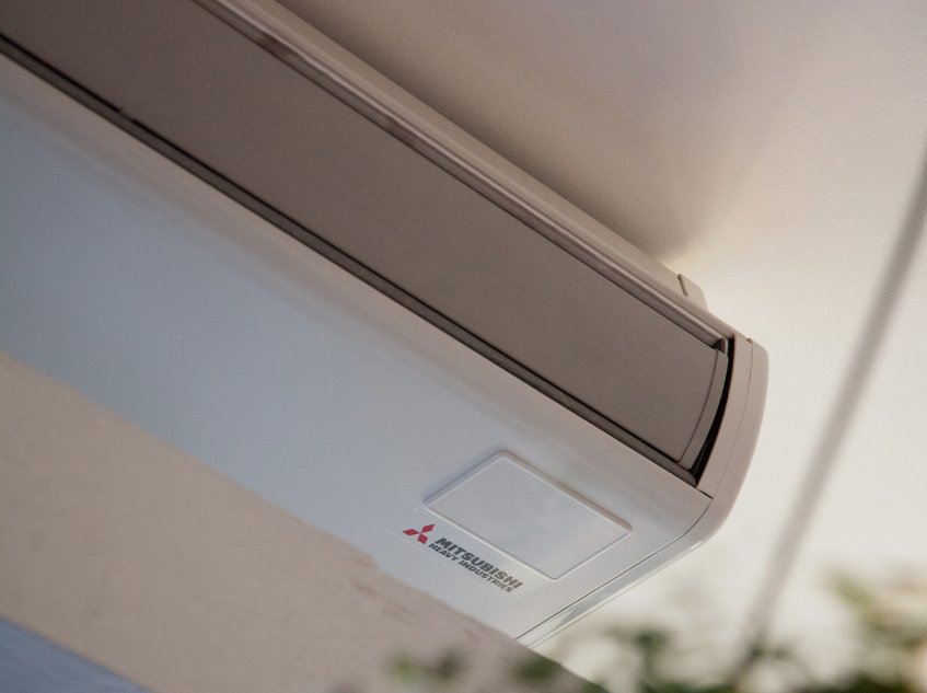 Wall-mounted Mitsubishi Air Conditioner Unit on a Ceiling Edge — GSA Group In Garbutt, QLD