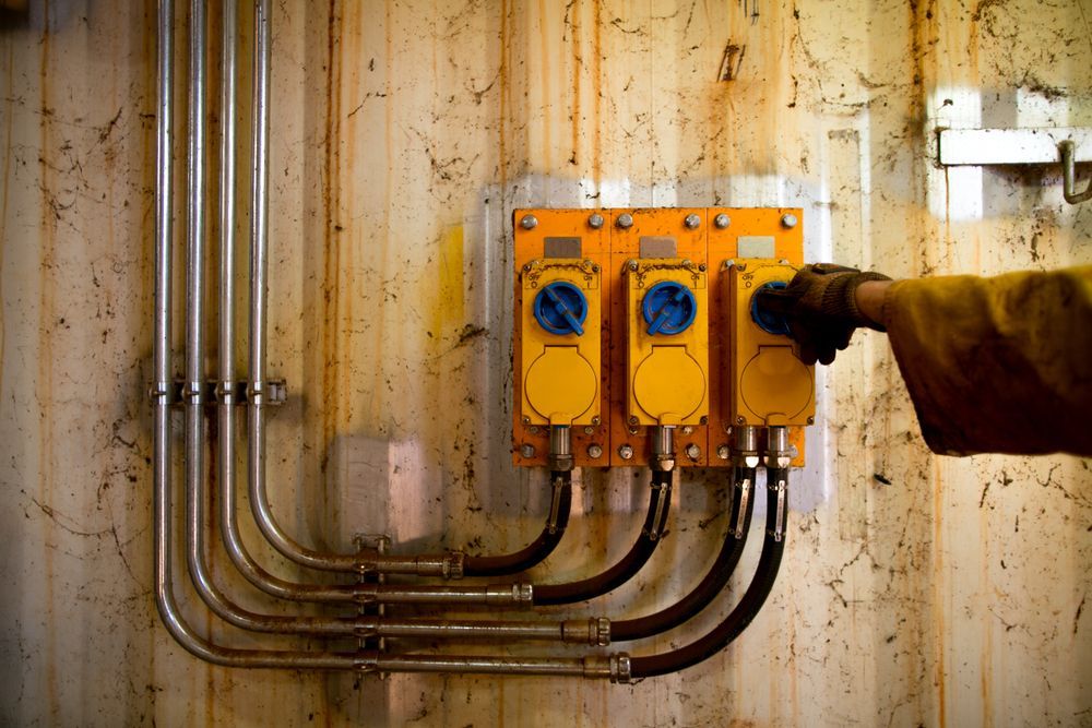 Man Is Pressing A Button On An Electrical Box — GSA Group In Garbutt, QLD