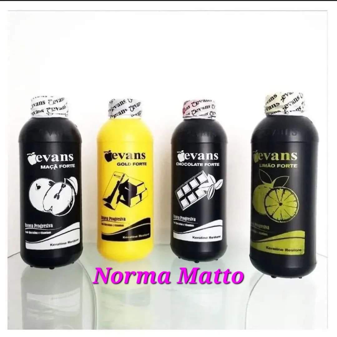 Cuatro botellas negras de líquidos "devans", cada una con una etiqueta diferente, sobre una superficie de vidrio.