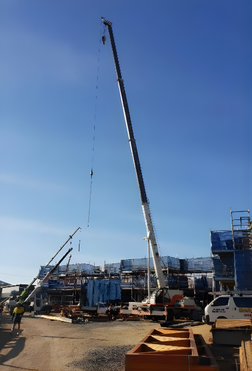 Construction Workers With Harnesses on a Job Site, Near Scaffolding — Mareeba Crane Hire In Mareeba, QLD