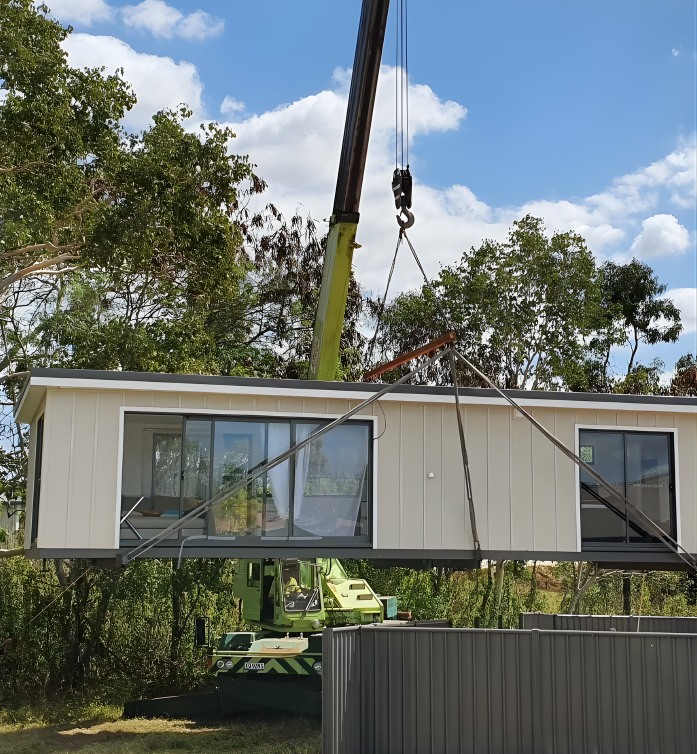 A Rigger Preparing An Orange Crane — Mareeba Crane Hire In Mareeba, QLD