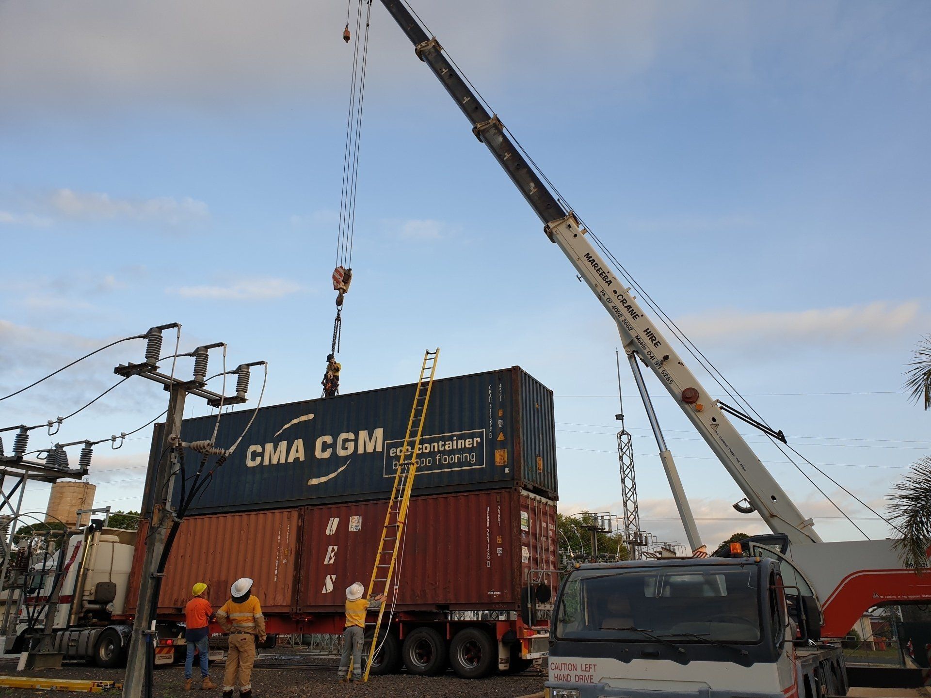 Crane Lifting Shipping Containers Near Power Lines — Mareeba Crane Hire In Mareeba, QLD