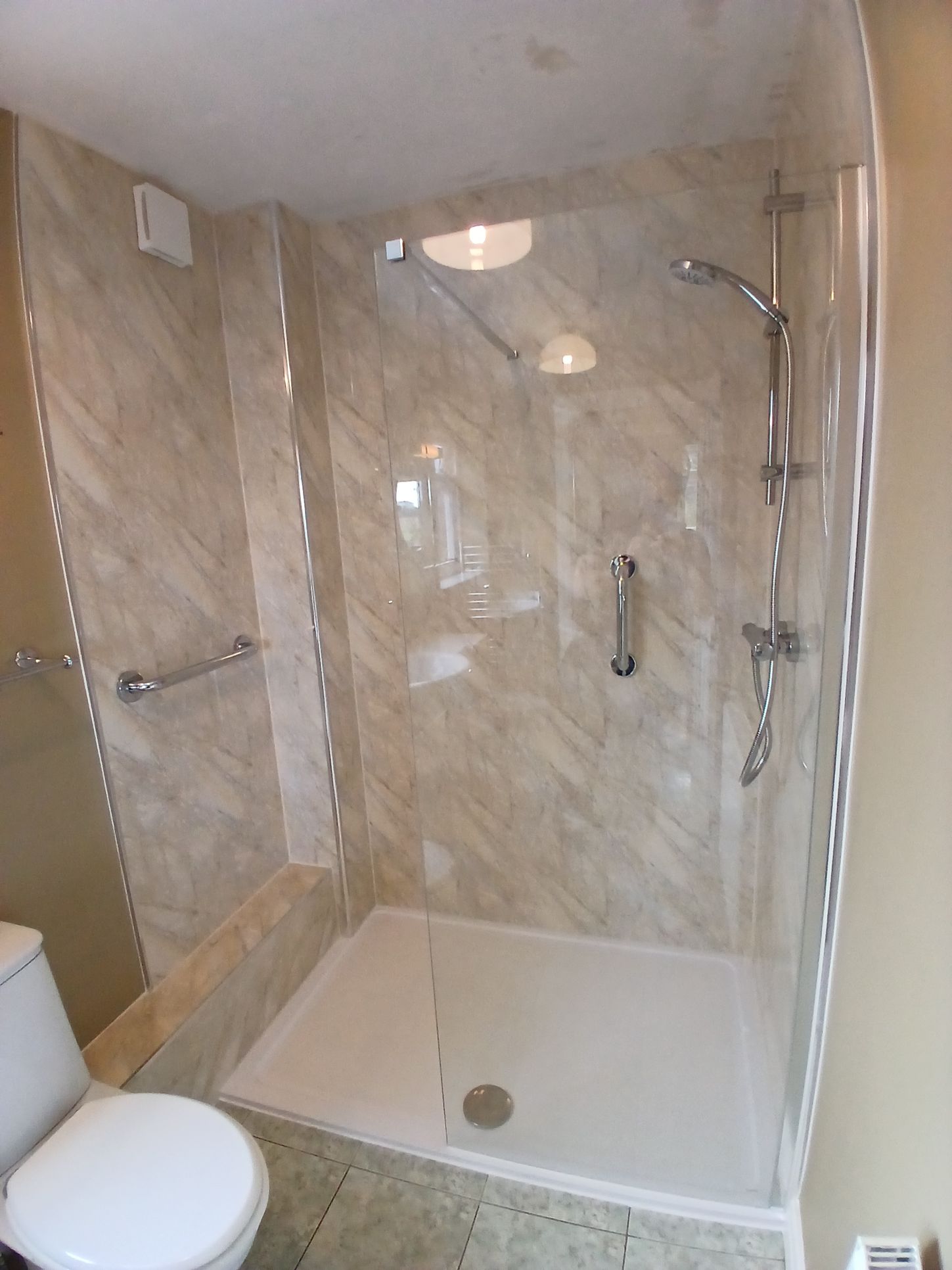 Shower room showing chrome grab rails