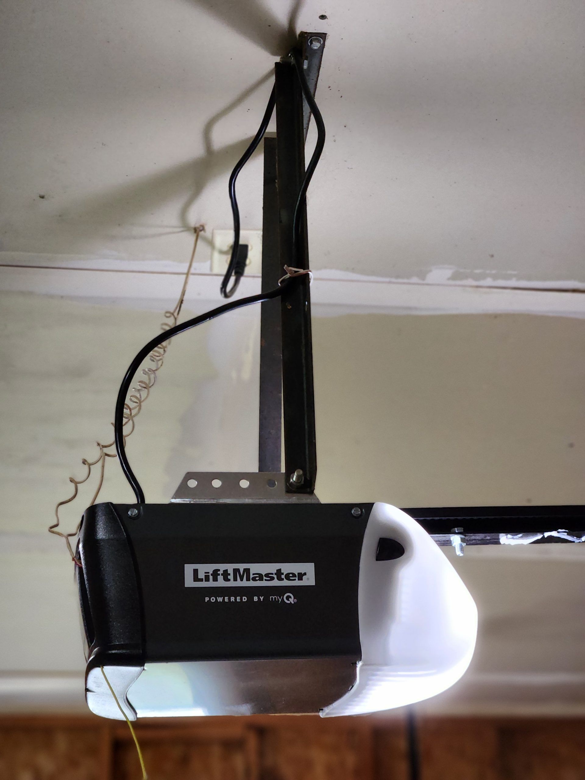 LiftMaster garage door opener mounted on a garage ceiling.