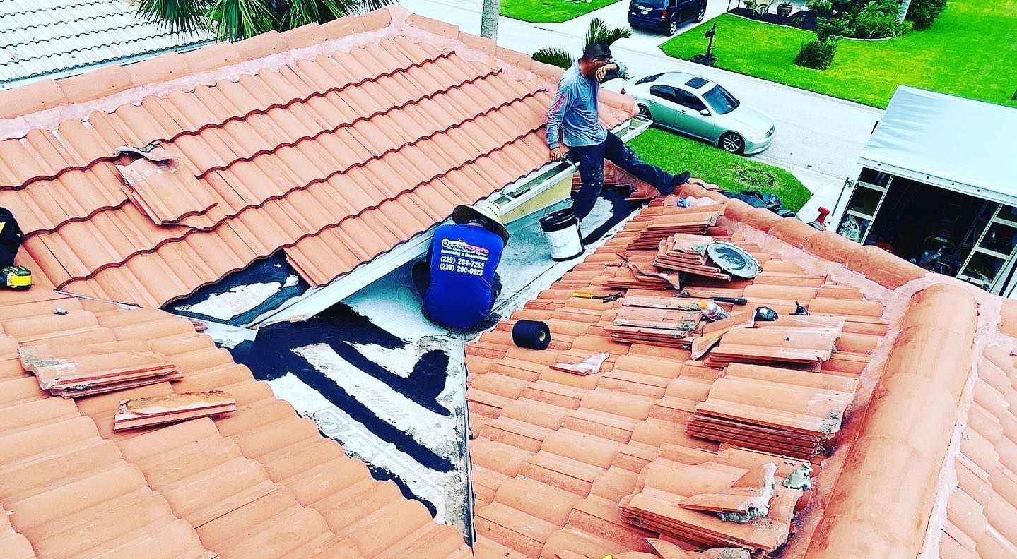 A man is working on the roof of a house.