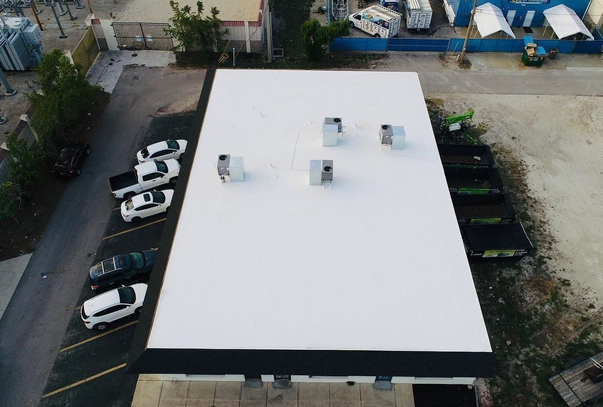 An aerial view of a building with a white roof.