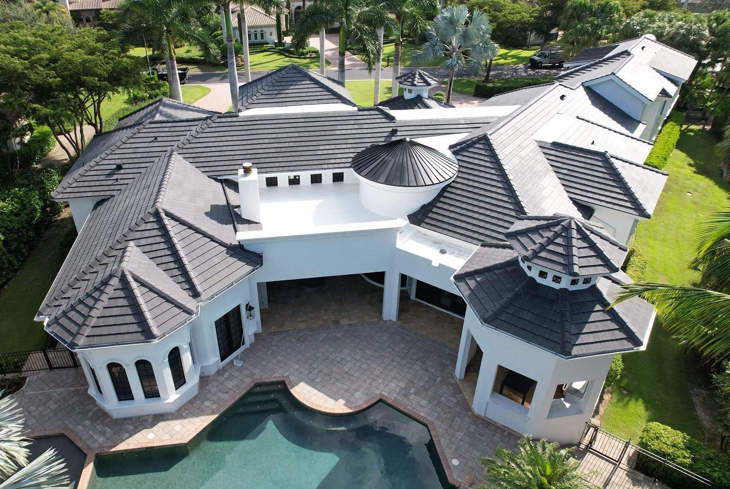 An aerial view of a large house with a pool