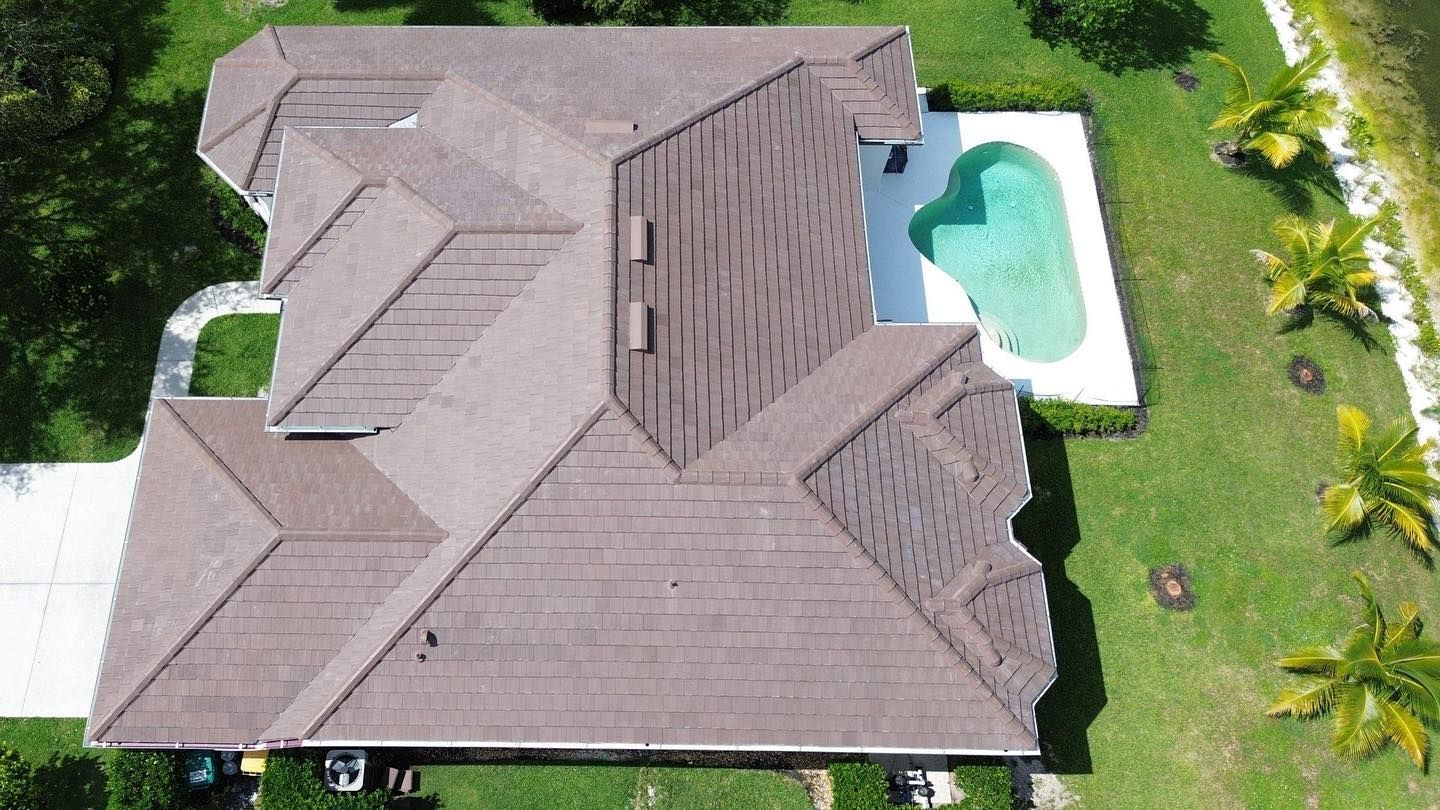An aerial view of a house with a pool in the backyard.