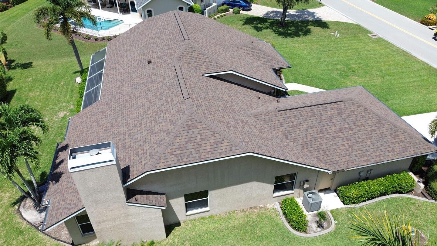 An aerial view of a house with a brown roof