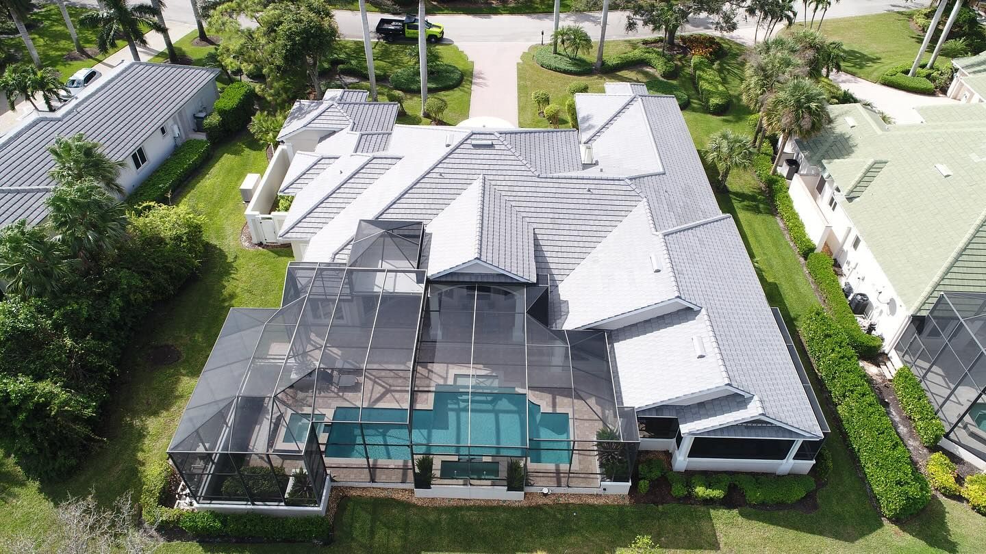An aerial view of a large house with a pool in the backyard.
