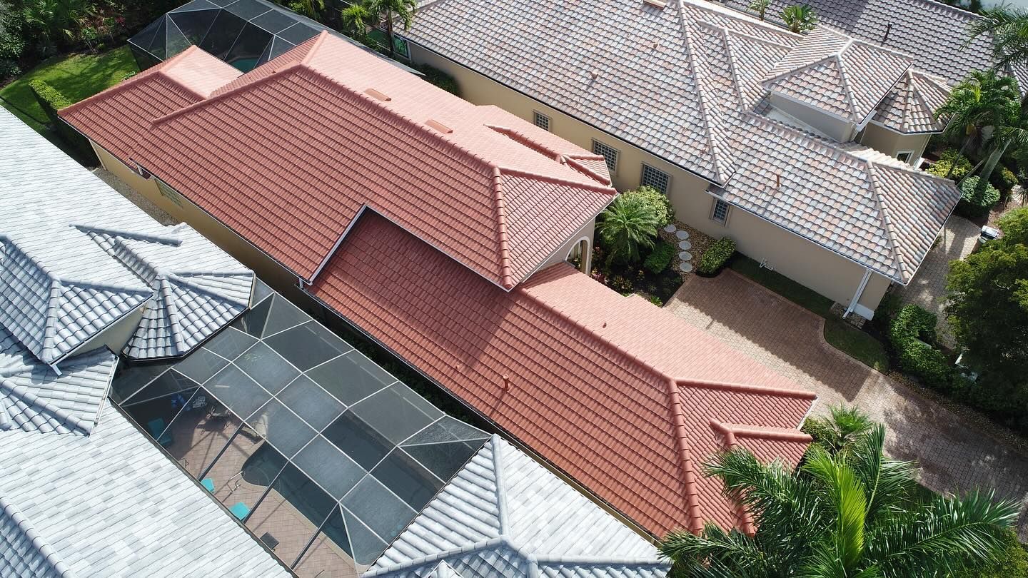 An aerial view of a row of houses with red tile roofs.