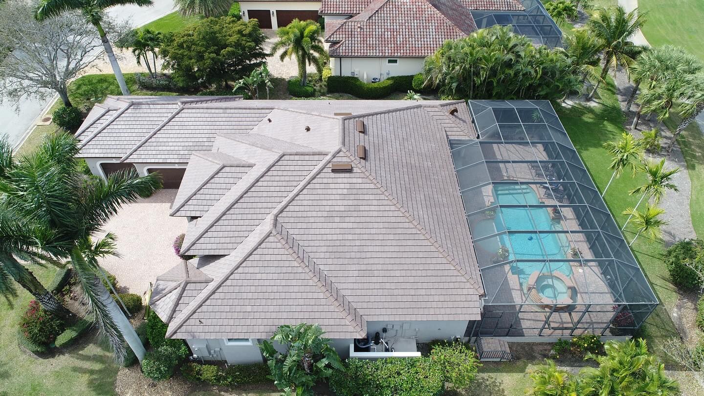 An aerial view of a house with a pool in the backyard.