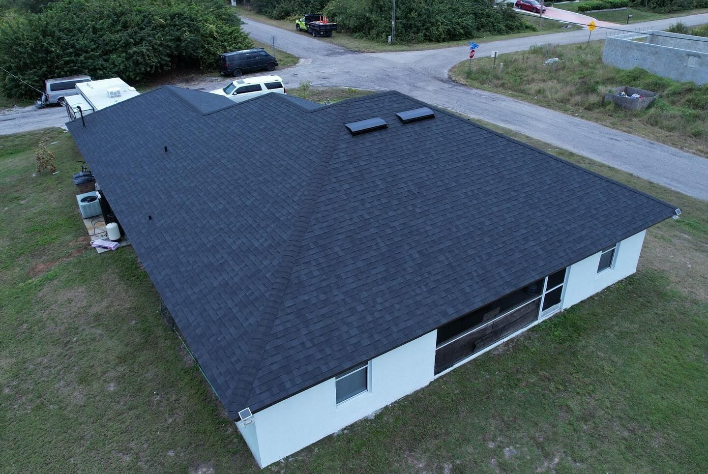 An aerial view of a house with a black roof.