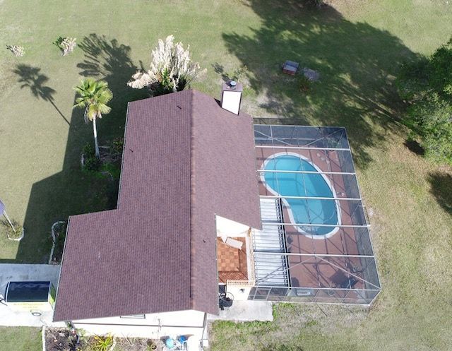 An aerial view of a house with a pool in the backyard.