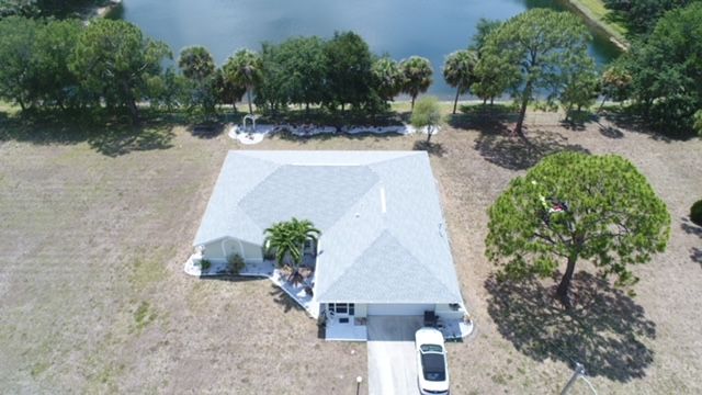 An aerial view of a house with a car parked in front of it.