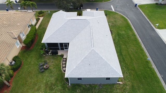 An aerial view of a house with a new roof.