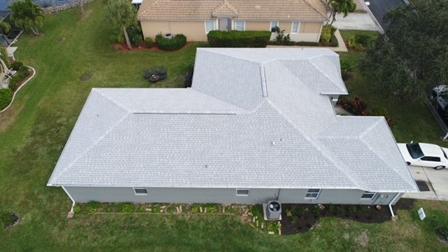 An aerial view of a house with a new roof.